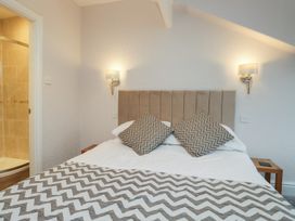 A bedroom with a bed and en-suite shower at Norwood House in Ambleside