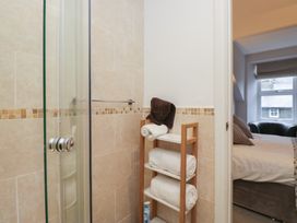 A bathroom with a shower and towels at Norwood House Ambleside