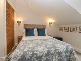 A bedroom with a bed and wall art at Norwood House in Ambleside