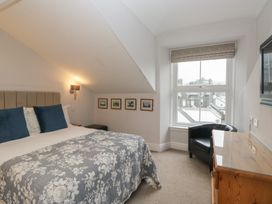 A bedroom with a bed and window at Norwood House in Ambleside