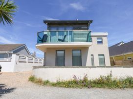 A house with a balcony and windows at Shearwater in Rhosneigr