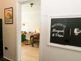 A dining room with a table and chairs at Seagull & Chips in Weymouth