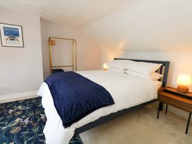 A bedroom with a bed and bedside table at Seagull & Chips in Weymouth
