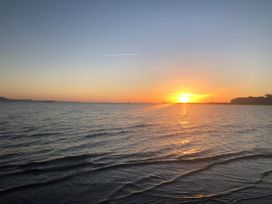 A sunset over the ocean at Seagull & Chips in Weymouth
