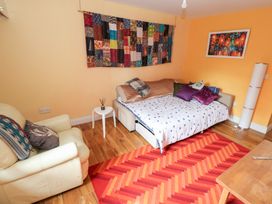 A living room with a sofa bed and coffee table at Huath in Carrick on Shannon