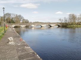 A river with a bridge and trees at Huath in Carrick on Shannon