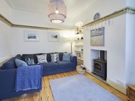 A living room with a sofa and a fireplace at Beachside Cottage in Sandsend