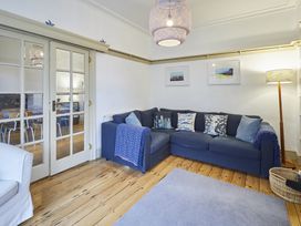 A living room with a sofa and a lamp at Beachside Cottage in Sandsend