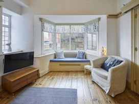A living room with a sofa and television at Beachside Cottage in Sandsend