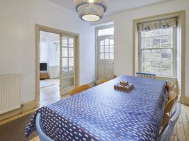A dining room with a table and chairs at Beachside Cottage in Sandsend