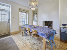 A dining room with a table and chairs at Beachside Cottage in Sandsend