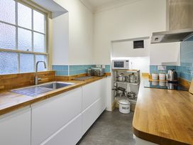 A kitchen with a sink and microwave at Beachside Cottage Sandsend