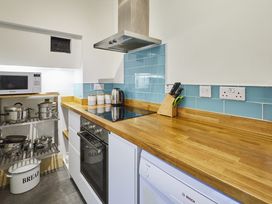 A kitchen with a countertop, microwave, and induction cooktop at Beachside Cottage in Sandsend