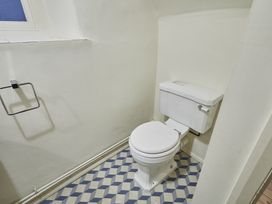 A bathroom with a toilet and a window at Beachside Cottage in Sandsend