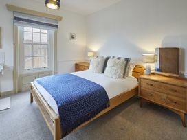 A bedroom with a bed and nightstand at Beachside Cottage in Sandsend