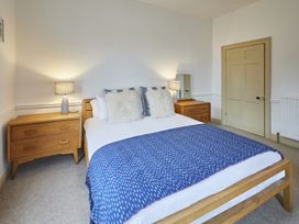 A bedroom with a bed and bedside tables at Beachside Cottage in Sandsend