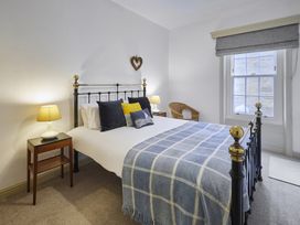 A bedroom with a bed and bedside table at Beachside Cottage in Sandsend