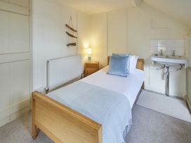 A bedroom with bed and nightstand at Beachside Cottage in Sandsend