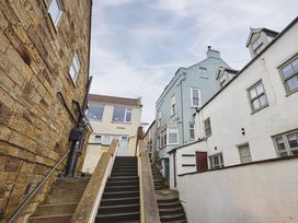 A staircase leading up between buildings at Beachside Cottage in Sandsend