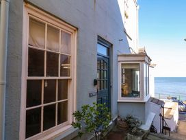 An exterior view of a building with a door and windows at Beachside Cottage in Sandsend