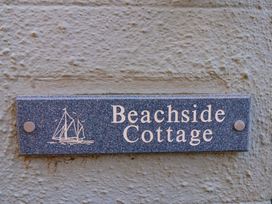 A nameplate with 'Beachside Cottage' and a boat illustration at Beachside Cottage in Sandsend