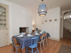 A dining room with a table set for dinner at Beachside Cottage in Sandsend