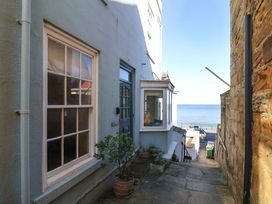 An outdoor area with a pathway and sea view at Beachside Cottage in Sandsend