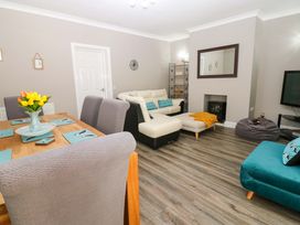 A living room and dining area with furniture at Amblers Rest in Amble