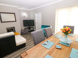 A dining table with flowers and chairs at Amblers Rest in Amble