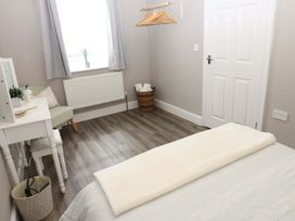A bedroom featuring a bed and desk at Amblers Rest in Amble