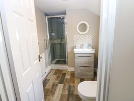 A bathroom with a shower and sink at Amblers Rest in Amble