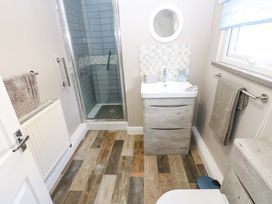 A bathroom with a shower and sink at Amblers Rest in Amble