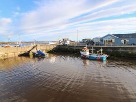 A harbor with boats and a building at Amblers Rest in Amble