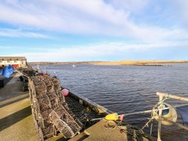 A view of a river with fishing equipment and boats at Amblers Rest in Amble