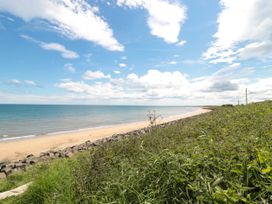 A beach with sand and water at Amblers Rest in Amble