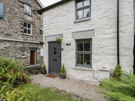 An entrance with a door and window at Squirrel Cottage in Betws-Y-Coed