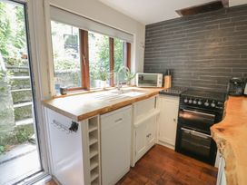 A kitchen with a sink and stove at Squirrel Cottage in Betws-Y-Coed
