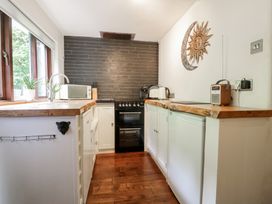 A kitchen with modern appliances at Squirrel Cottage in Betws-Y-Coed