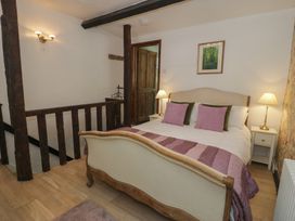 A bedroom with a bed and side tables at Squirrel Cottage in Betws-Y-Coed
