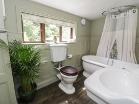 A bathroom with a bathtub and toilet at Squirrel Cottage in Betws-Y-Coed