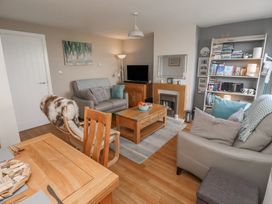 A living room with sofa and television at Tidal Watch in Seahouses