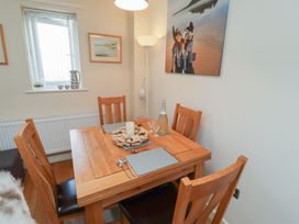 A dining room with a table set for meals at Tidal Watch in Seahouses