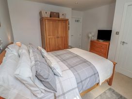 A bedroom with a bed and wardrobe at Tidal Watch in Seahouses