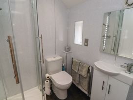 A bathroom with shower, toilet, and sink at Tidal Watch, Seahouses