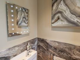 A bathroom with a mirror and sink at Tidal Watch in Seahouses