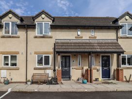 A house facade featuring benches and plants at Tidal Watch in Seahouses