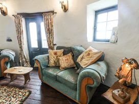 A living room with a sofa and coffee table at The Old Cornmill in Cemaes Bay