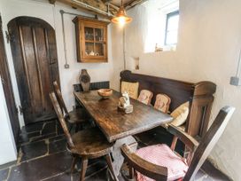 A dining room with a table and chairs at The Old Cornmill in Cemaes Bay