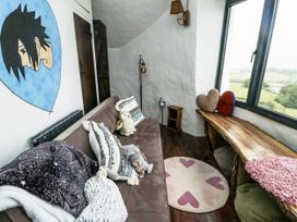 A snug with a sofa and wall art at The Old Cornmill in Cemaes Bay