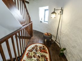 A stairway with a window and a lamp at The Old Cornmill in Cemaes Bay